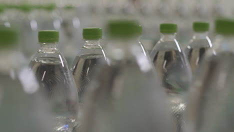 Plastic-bottles-filled-with-pure-mineral-water-on-a-conveyor-in-a-modern-water-filling-factory-with-shallow-depth-of-field