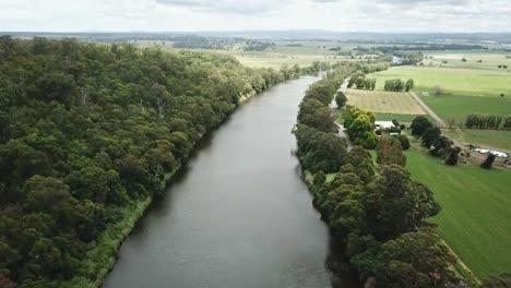 Sideways-drone-footage-over-the-Snowy-River-between-Marlo-and-Orbost,-in-Gippsland,-Victoria,-Australia,-December-2020
