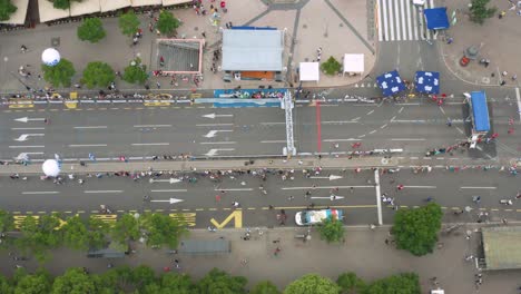 Overhead-aerial-shot-of-participants-arriving-at-the-finish-line-of-a-Marathon
