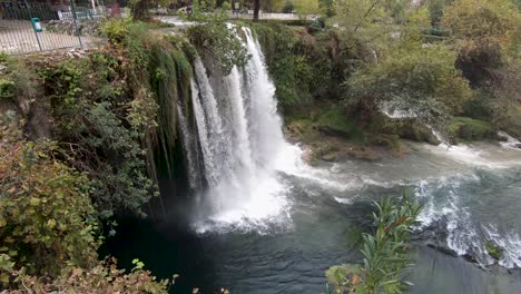 Tilting-shot-of-the-cascading-upper-Duden-waterfall-in-the-city-of-Antalya-Turkey,-bright-daylight