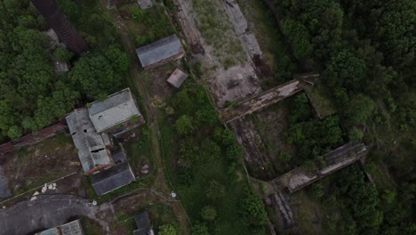 Abandoned-old-overgrown-coal-mine-industrial-museum-buildings-aerial-rooftop-view-top-down