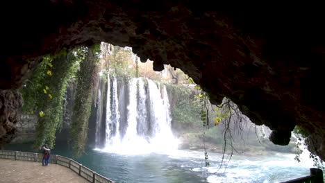 Dolly-shot-looking-at-the-upper-Duden-waterfall-from-inside-a-tunnel-to-revel-the-full-landscape,-bright-daylight
