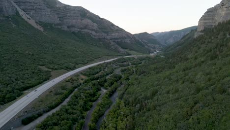Aerial-View-Of-Cars-Driving-In-Provo-Canyon-Road-Along-Provo-River-Through-Mountain-Ranges-In-Utah