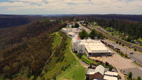 Aerial:-Flying-over-the-iconic-Hydro-Majestic-building-towards-the-tennis-courts-in-the-Blue-Mountains,-NSW,-Australia