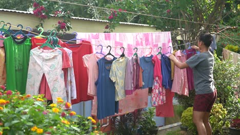 Filipina-Lady-Doing-Household-Chores-and-Drying-the-Hanging-Laundry-Clothes-at-the-Orphanage-Home-in-the-Philippines---static-shot