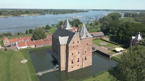 Drone-flying-around-monumental-Castle-Loevestein-near-river-Maas-in-the-Netherlands