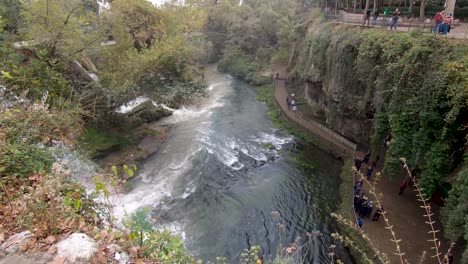 Passing-through-a-railing-panning-downwards-to-the-Duden-Falls-in-Antalya,-Turkey