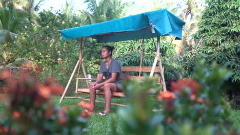 Lonely-And-Sad-Filipina-Orphan-Girl-Sitting-On-A-Swing-Chair-At-The-Orphanage-Home-In-The-Philippines---low-angle-shot