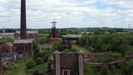 Abandoned-old-overgrown-coal-mine-industrial-museum-buildings-aerial-view