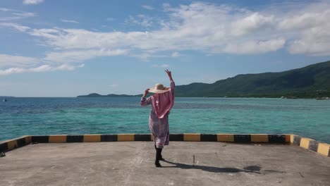 Woman-tourist-in-summer-hat-enjoying-summer-holiday-on-beautiful-sea