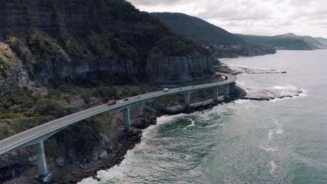 Aerial-View-Of-Vehicles-Travelling-At-Seacliff-Bridge-In-New-South-Wales,-Australia