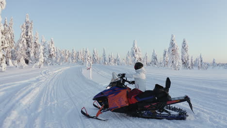 Close-up-of-a-man-on-a-snowmobile-during-a-cold-winter-in-Sweden