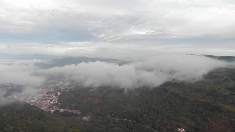 Drone-view-of-misty-morning-in-a-village-in-middle-of-mountains