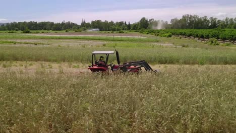 Farmer-Mowing-Farmland-With-Modern-Agricultural-Machine