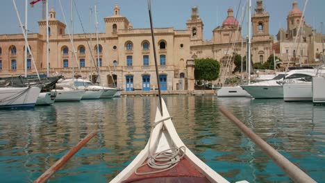 Three-cities-harbor-view-from-Maltese-Gondola-boat-with-yacht-port-and-ancient-architectural-buildings---POV-shot