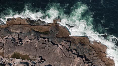 Aerial-View-Of-Waves-Crashing-Against-Rocky-Coast-Freshwater-Beach-In-NSW,-Australia