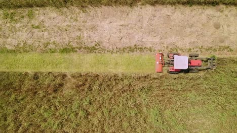 Top-View-Of-A-Farmer-Mowing-With-An-Agriculture-Machine