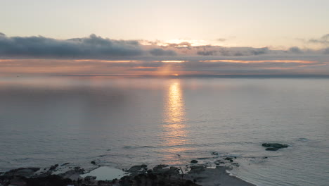 Aerial-of-sun-behind-the-clouds-and-Clifton-Beach-in-Cape-Town-in-South-Africa