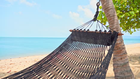 A-gentle-ocean-breeze-ripples-a-rope-hammock-over-the-white-sands-of-a-tropical-beach