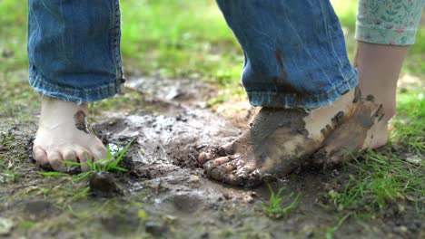 children's-bare-feet-playing-with-mud-on-a-sunny-day