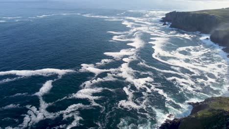 4K-Drone-footage-of-Lands-End-cliffs-with-a-small-island-with-waves-and-sea-mist