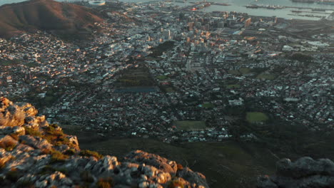 Aerial-revealing-Sunrise-over-Cape-Town-city-seen-from-Table-Mountain
