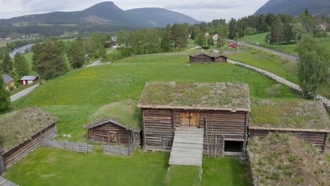 Aerial-view-over-traditional-Norwegian-cottages-and-farm-has-green-roofs-in-tynset-town-in-Norway-on-June-25,-2021