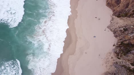 AERIAL-Top-Down-Fly-By-of-the-Wild-Waves-at-Praia-da-Ursa,-Portugal