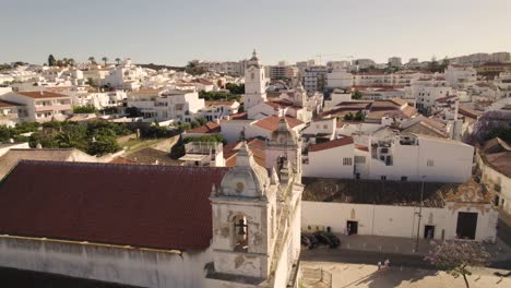 Panorama-Aéreo-Lento-Sobre-La-Iglesia-De-Nossa-Senhora-Da-Assunção-Lagos,-Algarve