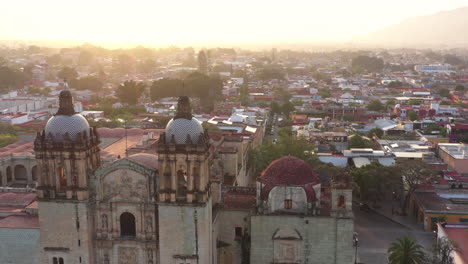 Aerial-View-of-Oaxaca-City,-Mexico-and-Santo-Domingo-de-Guzman-Church,-Religious-Colonial-Landmark-in-Historic-Unesco-Protected-Downtown,-Drone-Revealing-Shot
