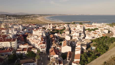 Fly-over-Lagos-city,-Algarve,-by-the-Atlantic-Ocean