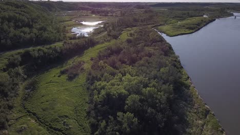 Lush-aerial-of-vivid-green-prairie-river-valley-wetland-marsh