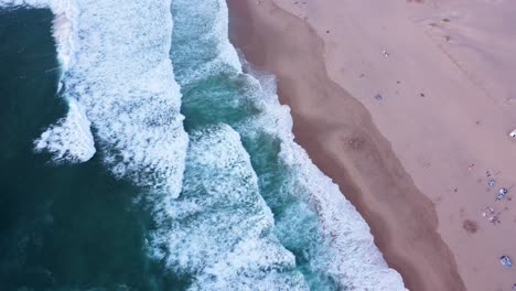 Orbiting-Top-Down-Shot-of-the-Waves-at-Guincho-Beach,-Portugal