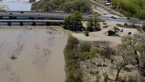 Bridge-with-Cars-and-Traffic-Crossing-Rio-Grande-River-in-New-Mexico---Drone