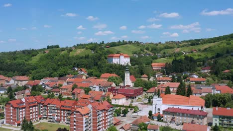 Aerial-pedestal-shot-lowering-down-into-the-town-of-Lendava,-Slovenia-on-a-bright-summer-day