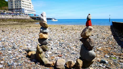Colourful-rocks-tower-arrangement-balanced-on-sunny-Llandudno-beach-seaside-shoreline