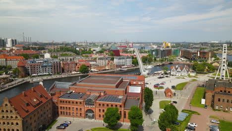 Aerial-View-Of-Hotel-KROLEWSKI-And-Philharmonic-Hall-Along-Motlawa-River-In-Gdansk,-Poland