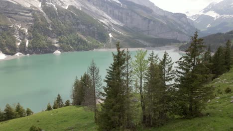 Circling-through-the-abundant-forest-of-fir-trees-with-the-Oeschinen-valley-and-lake-in-the-background