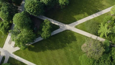 Top-Down-View-of-University-Campus-with-Common-Lawn,-Walking-Paths,-and-Beautiful-Green-Trees