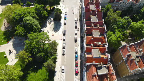 Aerial-view-of-street-near-the-park-in-Old-Town-Gdansk-with-many-cars-parked-near-the-buildings-in-summer