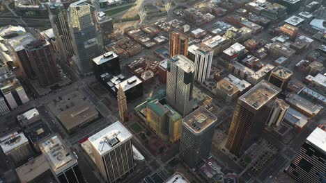 Downtown-Denver-Colorado,-USA,-Birdseye-Aerial-View-of-Skyscrapers,-Daniels-and-Fisher-Tower-on-Golden-Hour-Sunlight,-Drone-Shot