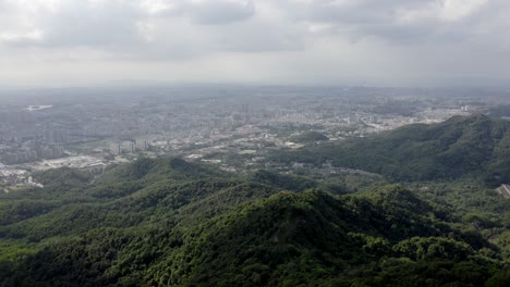 Aerial:-Guangzhou-city-in-Chinese-mountainside,-view-from-Baiyun-Shan