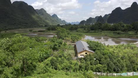 Aerial:-beautiful-Chinese-farming-village-in-karst-mountain-landscape