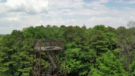 Area-viewpoint-tower-of-majestic-forestry-landscape-in-close-by-drone-view