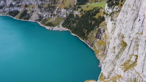 Amazing-Turquoise-lake-Oeschinensee,-on-an-autumn-evening,-in-Kandersteg,-Bern,-in-the-alps-of-Switzerland