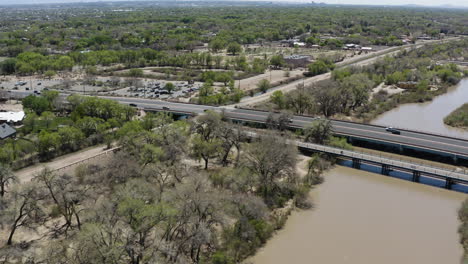 Bridge-over-Rio-Grande-River-with-Cars-Driving-to-Albuqurque,-New-Mexico---Aerial