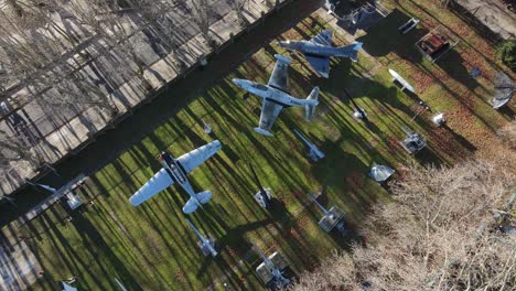 Aerial-flyover-air-force-museum-with-planes-in-National-Aeronautics-Museum-in-Argentina-during-sunny-day-outdoors