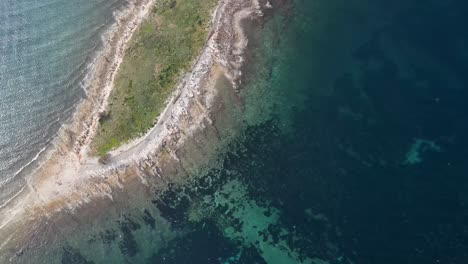 View-from-above-of-Flock-of-Seagulls-flying-over-seashore-land,-Dugi-Otok,-Croatia