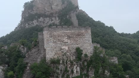 View-of-deteriorated-square-lookout-tower-of-Great-Wall-of-China,-on-a-cloudy-day