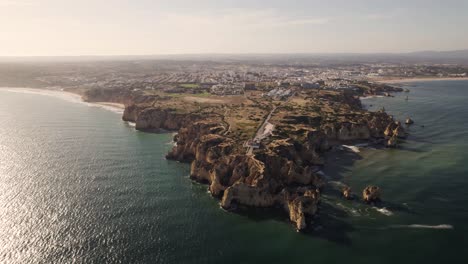 Panoramic-aerial-view-of-Farol-da-Ponta-da-Piedade,-lighthouse-in-Lagos-,-Algarve,-Portugal